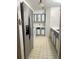 The kitchen features stainless steel refrigerator and blue accents on the cabinets at 14602 E 2Nd Ave # 108-C, Aurora, CO 80011