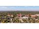 A scenic aerial view of red-roofed buildings surrounded by lush trees and the Denver skyline in the distance at 1755 Quince St, Denver, CO 80220