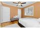 Bright bedroom with a light colored rug, white bedding, and a ceiling fan at 1755 Quince St, Denver, CO 80220
