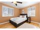 Inviting bedroom with warm tones, wood floors, two windows, and a comfortable-looking bed at 1755 Quince St, Denver, CO 80220