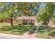 Well-kept single-story home with a manicured lawn and mature trees at 1755 Quince St, Denver, CO 80220