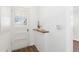 Bright hallway features a white door with glass, white walls, and a wooden shelf detail at 1755 Quince St, Denver, CO 80220