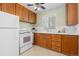 Well-lit kitchen with wooden cabinets, white countertops, and a ceiling fan for added comfort at 1755 Quince St, Denver, CO 80220