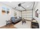 Bright living room with wood floors, a gray sofa, and a garage door visible at 1755 Quince St, Denver, CO 80220