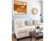 Bright living room decorated with neutral tones, featuring a cozy couch and wood flooring at 1755 Quince St, Denver, CO 80220