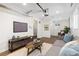 Inviting living room features wood floors, a cozy couch, a large TV, and natural light at 1755 Quince St, Denver, CO 80220