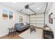 Cozy living room features wood floors, a comfortable couch, and natural light from a window at 1755 Quince St, Denver, CO 80220