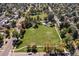 Aerial view of a well-maintained park with a playground and lush greenery, nestled in the surrounding neighborhood at 1755 Quince St, Denver, CO 80220