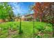 A sprawling backyard featuring vibrant greenery, a charming archway, a playground, and a covered patio for serene outdoor enjoyment at 4012 S Newport Way, Denver, CO 80237