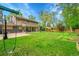 Expansive backyard with lush lawn, patio, swing set, and mature trees, perfect for outdoor activities and relaxation at 4012 S Newport Way, Denver, CO 80237