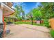 Large backyard featuring a basketball hoop, playground, covered patio, and lush green lawn offering outdoor fun and relaxation at 4012 S Newport Way, Denver, CO 80237