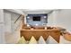 Basement with TV, stairs, carpet and a comfortable brown sofa at 4012 S Newport Way, Denver, CO 80237