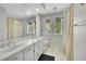 Bright bathroom with a double vanity, large mirror, and natural light at 4012 S Newport Way, Denver, CO 80237