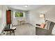 Cozy bedroom featuring a window with green views, a desk and comfortable seating at 4012 S Newport Way, Denver, CO 80237