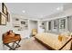 Cozy bedroom with neutral walls, built-in shelving, and large window at 4012 S Newport Way, Denver, CO 80237
