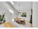 Bright dining room featuring vaulted ceilings, modern lighting, and stylish decor at 4012 S Newport Way, Denver, CO 80237
