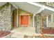 Close-up of the front door and porch area, showcasing stonework and architectural details at 4012 S Newport Way, Denver, CO 80237