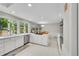 Spacious kitchen featuring white cabinets, granite counters, stainless steel appliances, and large windows providing ample natural light at 4012 S Newport Way, Denver, CO 80237