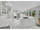Open kitchen featuring white cabinets, tile floors, stainless steel appliances and barstool seating at 4012 S Newport Way, Denver, CO 80237