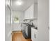 Well-equipped laundry room with modern washer and dryer, ample storage, and exterior access at 4012 S Newport Way, Denver, CO 80237