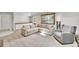 Bright living room featuring plush seating, natural light, and built-in storage at 4012 S Newport Way, Denver, CO 80237