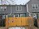 Townhouse exterior with gray siding, wood fence, and a gate at 4211 E 94Th Ave # C, Thornton, CO 80229