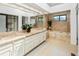 Bright bathroom featuring double sinks, soaking tub, and tile surround at 9400 E Iliff Ave # 292, Denver, CO 80231