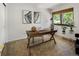 Bedroom with a wooden desk, art and plenty of natural light, creating an inviting and functional space at 9400 E Iliff Ave # 292, Denver, CO 80231