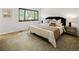 Bright bedroom with large window, king bed, side tables, and accent lighting, offering a comfortable living space at 9400 E Iliff Ave # 292, Denver, CO 80231
