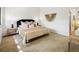 Bedroom featuring a king bed with decorative pillows, side tables, and stylish wall decor for a serene retreat at 9400 E Iliff Ave # 292, Denver, CO 80231