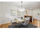 Dining room with contemporary lighting, artwork, seating for four, and access to other living spaces at 9400 E Iliff Ave # 292, Denver, CO 80231