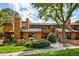 Charming home with lush greenery, a brick-paved walkway, a cozy front patio, and beautiful, mature trees at 9400 E Iliff Ave # 292, Denver, CO 80231