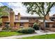 Attractive townhome exterior with wood siding, brick accents, and manicured landscaping at 9400 E Iliff Ave # 292, Denver, CO 80231