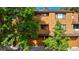 Townhome exterior featuring wood siding, driveway, and mature trees at 9400 E Iliff Ave # 292, Denver, CO 80231