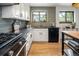 Updated kitchen featuring black countertops, stainless steel appliances, and views from the bright window at 9400 E Iliff Ave # 292, Denver, CO 80231