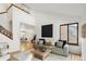 Spacious living room boasting a large sectional, tall ceilings, wood floors, and an adjacent dining area at 9400 E Iliff Ave # 292, Denver, CO 80231