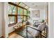 Bright sunroom area featuring a large window with backyard views, stylish decor, and ample sunlight at 9400 E Iliff Ave # 292, Denver, CO 80231