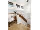 Bright landing area with stylish chair, modern railing, and unique light fixture enhances the home's modern design at 9400 E Iliff Ave # 292, Denver, CO 80231