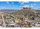 Stunning aerial view highlighting a thriving neighborhood near mountains, bridges, and lush green spaces on a clear, sunny day at 109 Cantril St, Castle Rock, CO 80104