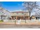 Charming two-story home featuring a brick foundation and a welcoming front porch, surrounded by a white picket fence at 109 Cantril St, Castle Rock, CO 80104