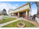 Welcoming home with a cozy front porch, enhanced by a well-manicured lawn and a classic white picket fence at 109 Cantril St, Castle Rock, CO 80104