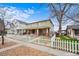 Inviting home with a brick foundation and charming front porch, enhanced by a classic white picket fence at 109 Cantril St, Castle Rock, CO 80104