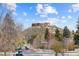 Picturesque neighborhood featuring a stunning rocky mountain backdrop, trees and well-maintained street at 109 Cantril St, Castle Rock, CO 80104