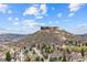 Scenic neighborhood view highlighting a prominent rocky mountain amidst lush greenery and residential homes at 109 Cantril St, Castle Rock, CO 80104