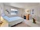 Bright bedroom with a comfortable bed, wooden desk, and ample natural light from a large window at 3915 Miller St, Wheat Ridge, CO 80033