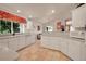 Spacious kitchen with white cabinetry, tile flooring, and ample countertop space at 3915 Miller St, Wheat Ridge, CO 80033