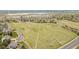 An aerial view captures a vast green field with winding roads, showcasing the potential of the surrounding area at 6740 S Windermere St, Littleton, CO 80120