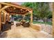 Inviting back patio features stylish seating under a charming pergola with string lights, perfect for outdoor entertaining at 6740 S Windermere St, Littleton, CO 80120