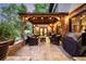 Relaxing outdoor patio with comfortable seating under a wooden pergola, complemented by a Traeger grill for outdoor cooking at 6740 S Windermere St, Littleton, CO 80120