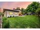 Expansive backyard features lush green grass, manicured landscaping, and a covered patio for serene outdoor living at 6740 S Windermere St, Littleton, CO 80120